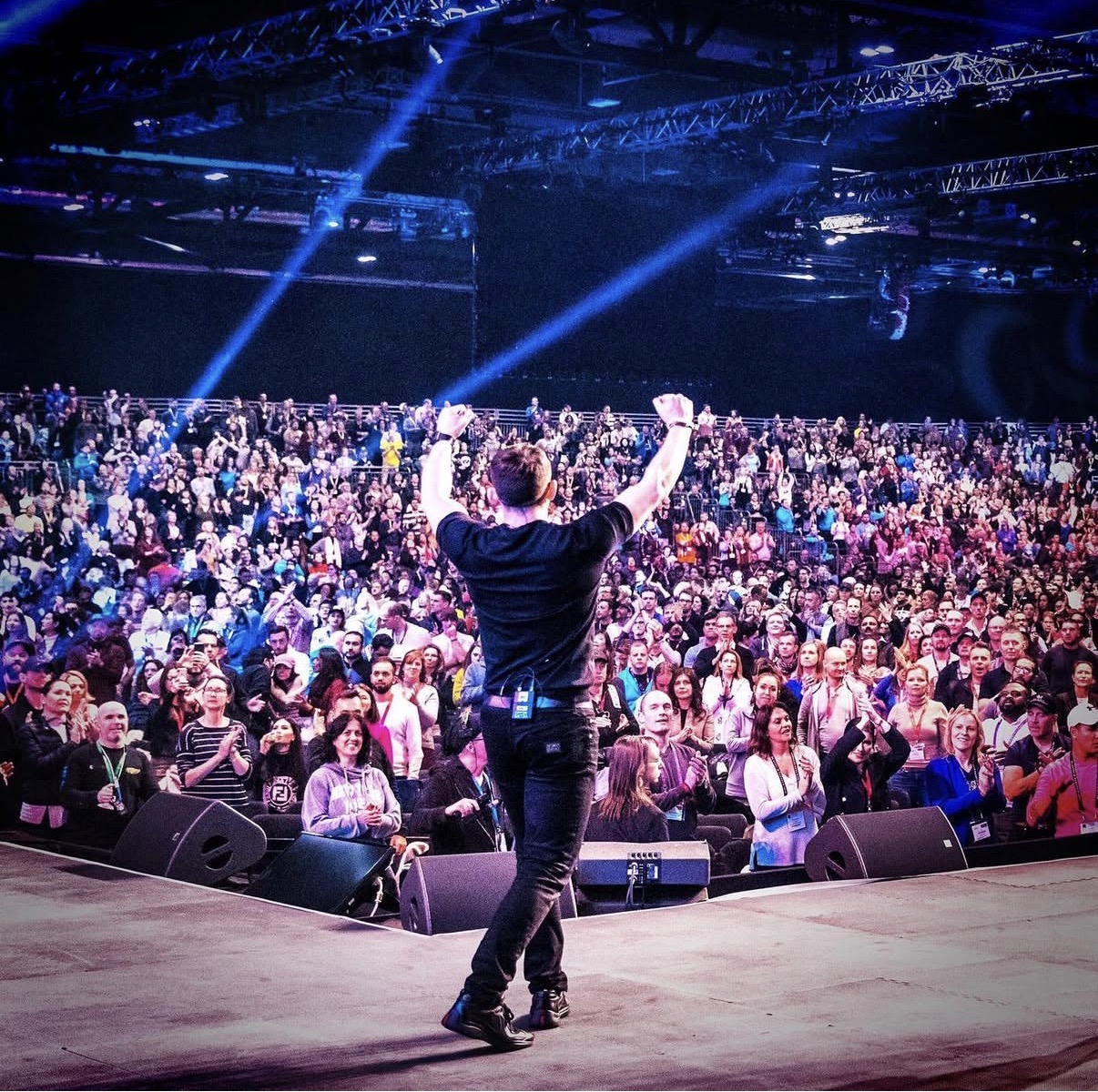 Gary Andrew Rhodes on stage in front of a large arena audience